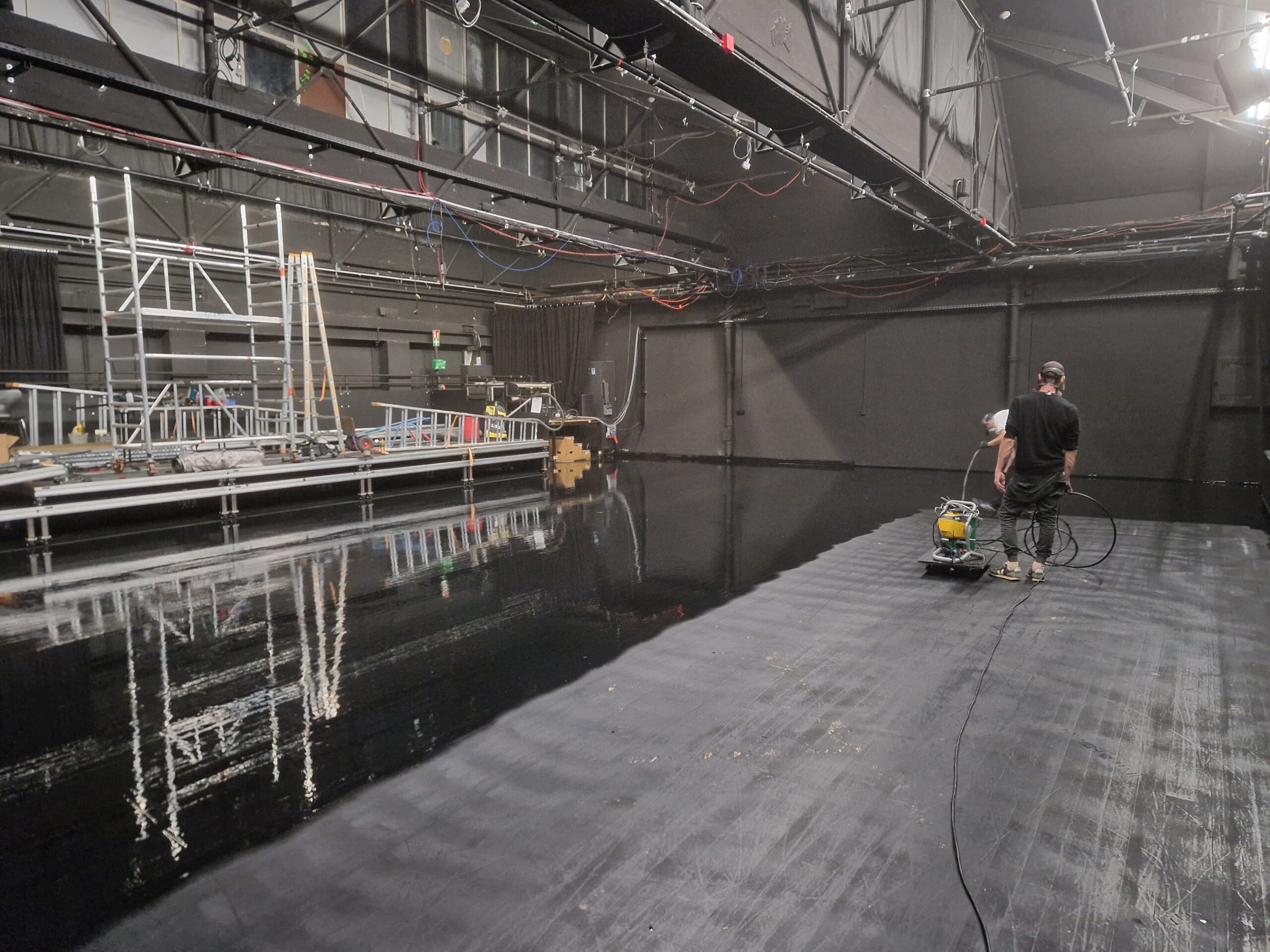 Das Technikteam des Frankfurt LAB streicht den Boden von Halle 2